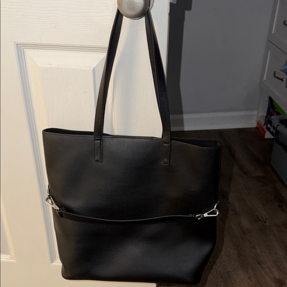 Away longitude tote bag with trap for travel over suitcase.